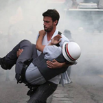 11.-Sao-Paulo-Brazil-2012-Brazilian-protester-carrying-an-injured-officer-to-safety.png