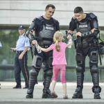12.-Bosnia-2013-Girl-hands-water-to-two-officers_thumb.png