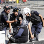13.-Ankara-Turkey-2013-Riot-police-help-a-womanaffected-by-tear-gas.png