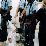 3.-Georgia-USA-1992-Child-touches-his-reflection-during-a-KKK-demonstration.png