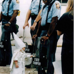 3.-Georgia-USA-1992-Child-touches-his-reflection-during-a-KKK-demonstration_thumb.png