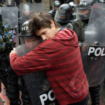 5.-Bogota-Colombia-2011-A-student-protesting-education-reform-hugs-a-policeman.png