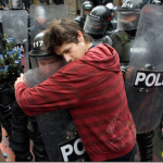 5.-Bogota-Colombia-2011-A-student-protesting-education-reform-hugs-a-policeman_thumb.png