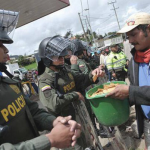 6.-Columbia-2013-Protestors-share-crackers-with-colombian-riot-police.png