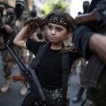 A Palestinian girl armed among militants.