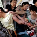 Bus passengers attempt to rescue a passenger attempting suicide.