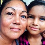 Mother and daughter with similar unusual eye colors.