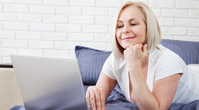 Middle,Aged,Woman,Working,On,Computer,In,Bed aging-hair-women